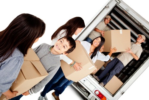 Man with van service loading items into a moving vehicle