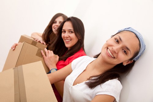 Careful loading of a sofa and dining furniture for removal in Chiswick